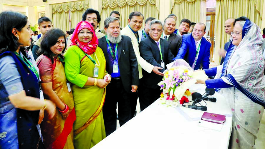 Officials of various public, private organisations and individuals presenting bouquets to Prime Minister Sheikh Hasina at Ganabhaban on Wednesday on her party's landslide victory in 11th national election. BSS photo