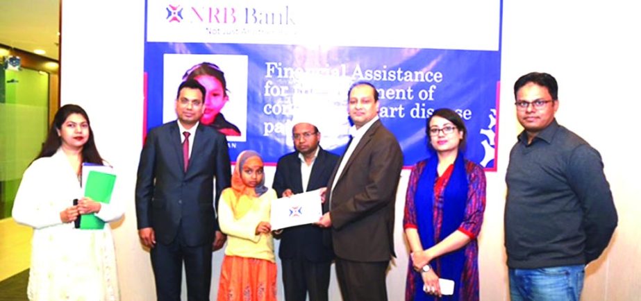 Imran Ahmed, Chief Operating Officer along with Mohd. Jamil Hossain, Head of Credit Risk Management & Sustainable Finance Unit of NRB Bank Limited, handing over a cheque of TK 100,000- to Meher Jahan, a 11 years old patient with congenital heart disease