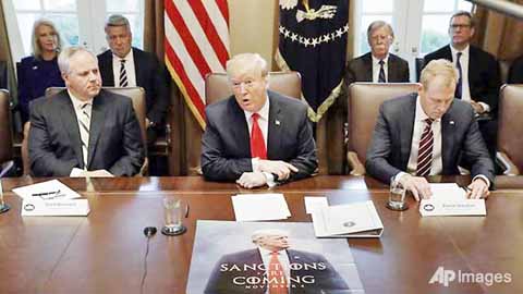 President Donald Trump (centre) speaks during a cabinet meeting at the White House in Washington, DC.