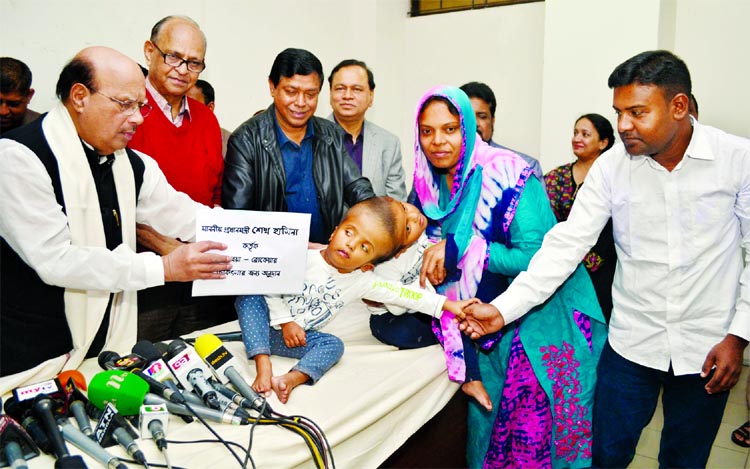 Health and Family Welfare Minister Mohammad Nasim handed over ticket to the parents of head conjoined children Rabeya and Rokaiya for going to Hungery for better treatment when the minister visited their at Burn Unit of Dhaka Medical College and Hospital