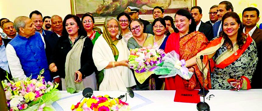 A business community team led by FBCCI President Md. Shafiul Islam Mohiuddin, congratulating Prime Minister Sheikh Hasina with flower bouquet on Wednesday at Gono Bhaban on the landslide victory at the 11th National Parliament election. leaders from all b