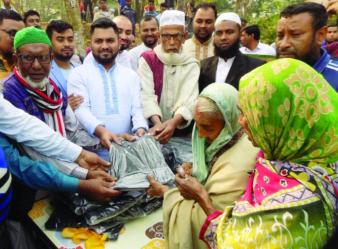 BHALUKA (Mymensingh): Mustafizur Rahman Mamun, Managing Director, Supti Sweater Ltd distributing warm clothes among the cold- hit people at Habirbari Union on Friday.