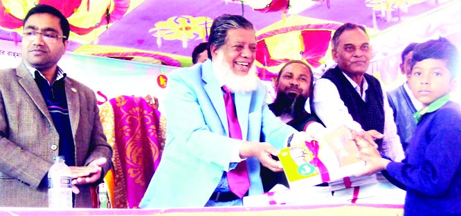 SAGHATA (Gaibandha): Deputy Speaker of the Jatiya Sangsad Adv Fazley Rabbi Miah MP distributing textbooks among the students of Bonarpara Model Govt Primary School on the occasion of Textbook Festival on Tuesday.