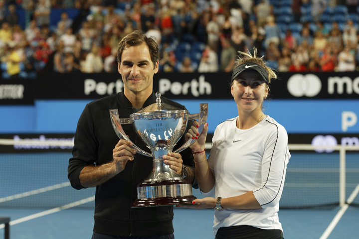 Switzerland's Roger Federer and Belinda Bencic hold the trophy after winning the final against Alexander Zverev and Angelique Kerber of Germany at the Hopman Cup in Perth, Australia on Saturday.
