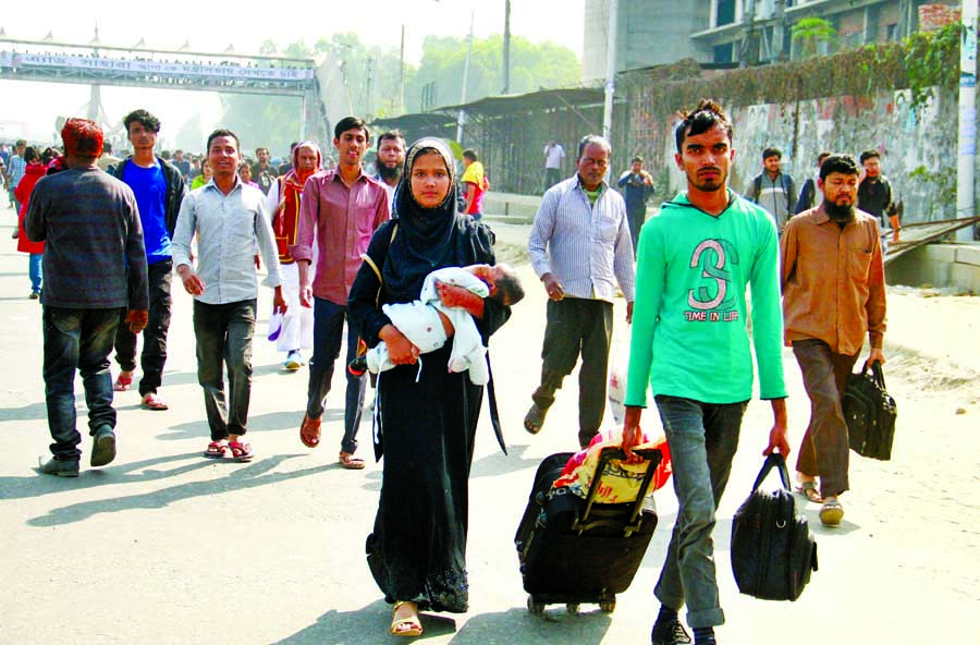 Air passengers and commuters walking on foot underpass on the Airport Road, Dhaka on Sunday due to the RMG workers' demonstration for arrear salary and other dues on Sunday.