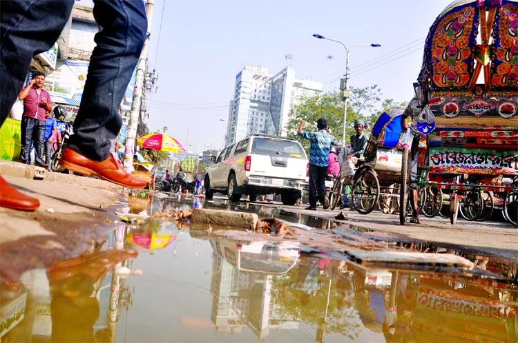 Dirty drainage water submerged city road at Purana Paltan area. This photograph was taken on Sunday.