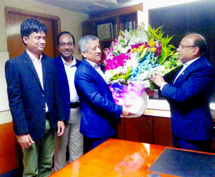 LGED Chief Engineer Md Abul Kalam Azad greeting LGRD and Cooperatives Minister Tajul Islam, MP with bouquet at his Tejgaon office in the city yesterday.