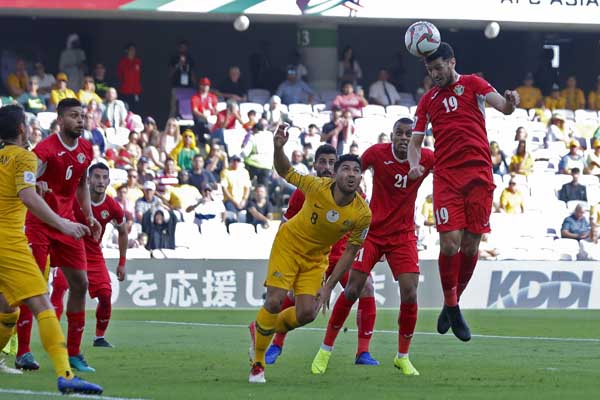 Jordan's defender Anas Bani Yaseen (top right) heads the ball to score the opening goal during the AFC Asian Cup group B soccer match between Australia and Jordan at Hazza bin Zayed stadium in Al Ain, United Arab Emirates on Sunday.