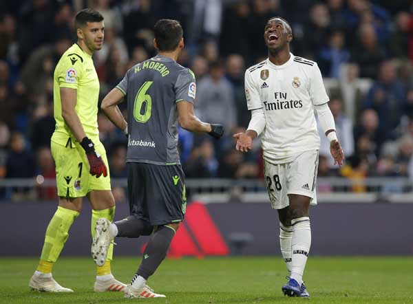 Real Madrid's Vinicius Junior (right) reacts during a Spanish La Liga soccer match between Real Madrid and Real Sociedad at the Santiago Bernabeu stadium in Madrid, Spain on Sunday.