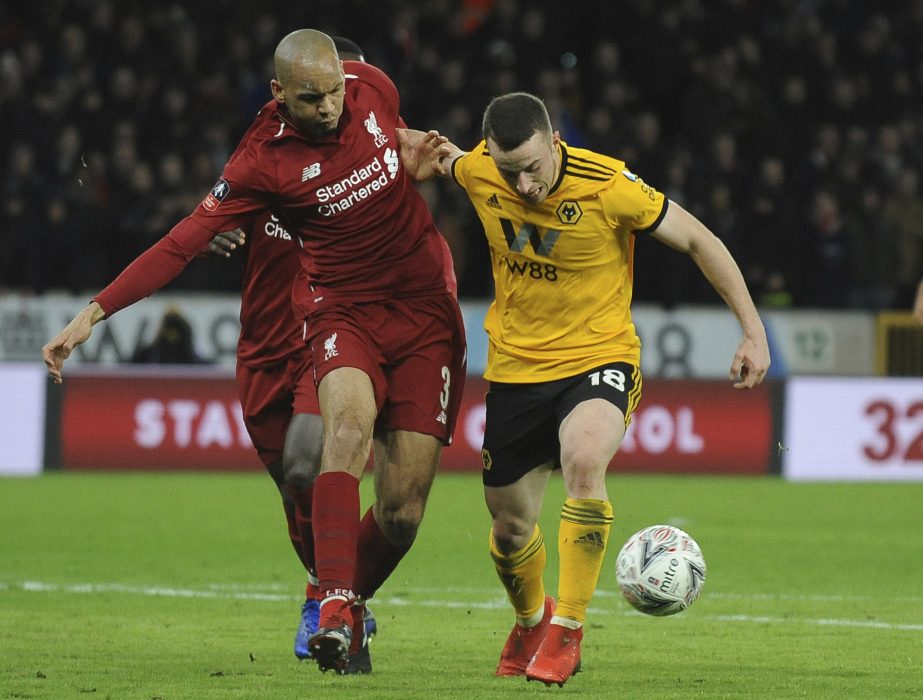 Liverpool's Fabinho (left) competes for the ball with Wolverhampton's Diogo Jota during the English FA Cup third round soccer match between Wolverhampton Wanderers and Liverpool at the Molineux Stadium in Wolverhampton, England on Monday.