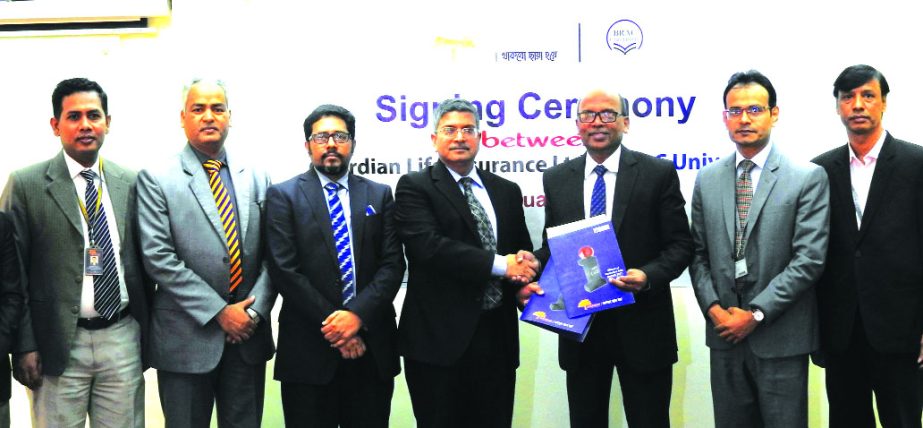 SN Kairy, Treasurer of BRAC University and M M Monirul Alam, Managing Director of Guardian Life Insurance Limited (GLIL), exchanging an agreement signing document to ensure Group Life and Health Insurance coverage for the employees of the university along