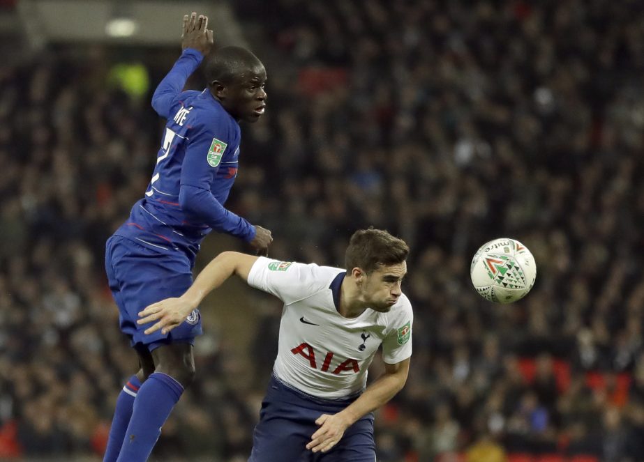 Tottenham's Harry Winks (right) and Chelsea's N'Golo Kante jump for the ball during the English League Cup semifinal first leg soccer match between Tottenham Hotspur and Chelsea at Wembley Stadium in London on Tuesday.