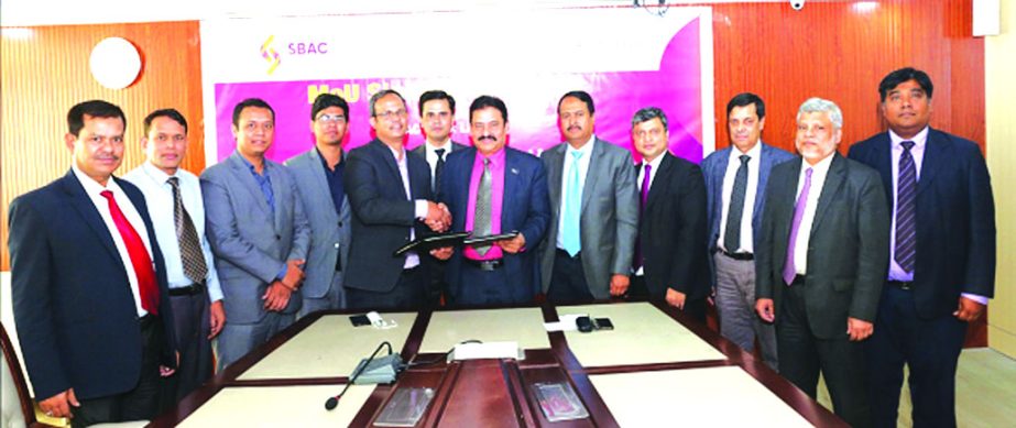 Mostafa Jalal Uddin Ahmed, AMD of South Bangla Agriculture and Commerce (SBAC) Bank Limited and Syed Yameenul Huq, Director (Sales and Marketing) of Royal Tulip Luxery Hotels, Cox's Bazar, exchanging a MoU signing documents at the Banks head office in th