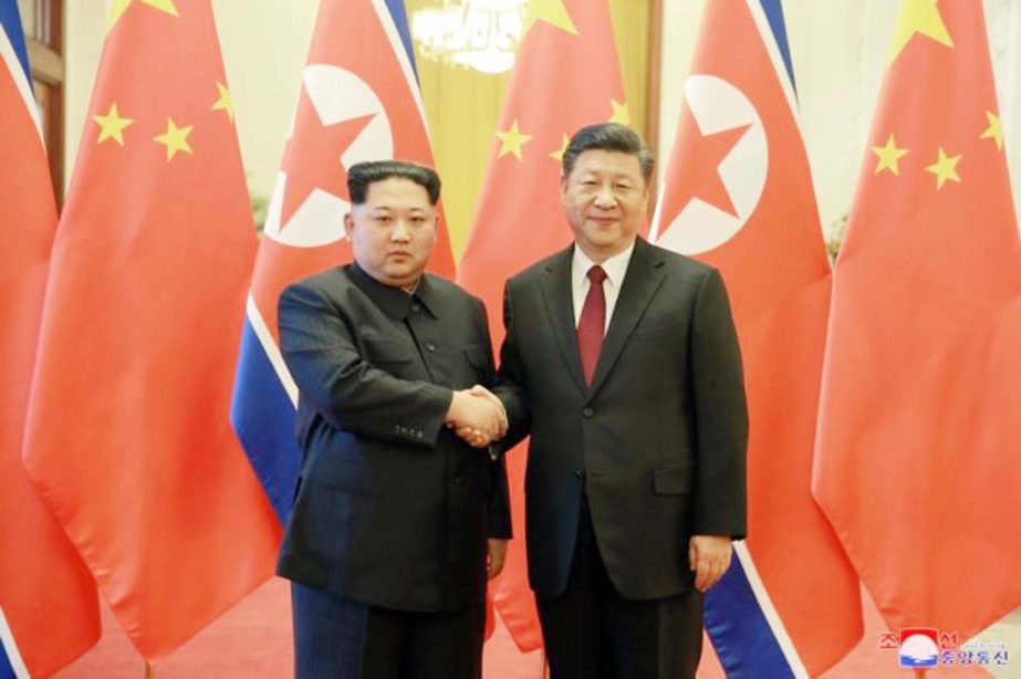 North Korean leader Kim Jong-un shaking hands with Chinese President Xi Jinping during visit to Beijing.