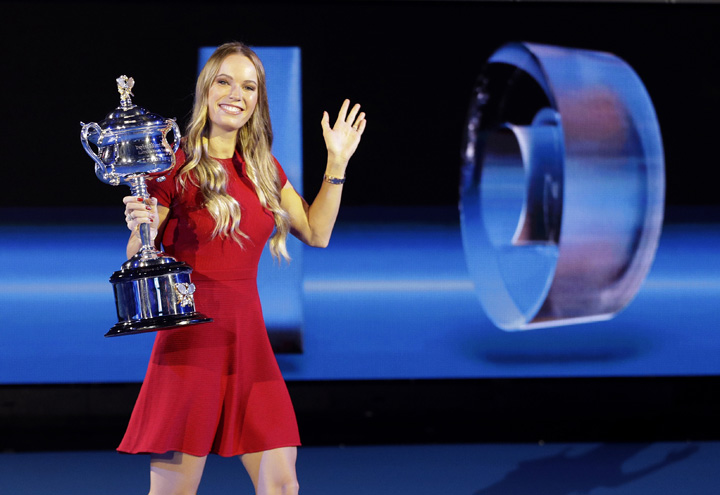 Defending women's champion Denmark's Caroline Wozniacki waves as she holds the Daphne Akhurst Memorial Cup during a photo opportunity at the official draw ceremony ahead of the Australian Open tennis championships in Melbourne, Australia on Thursday.