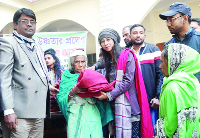 GANGACHARA (Rangpur ): An organization distributing warm clothes among the cold-hit people at Gangachara in Rangpur yesterday.