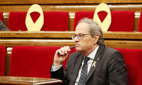 Catalan regional President Quim Torra speaks during an interview with the Associated Press, at the Palace of Generalitat or Catalan government headquarters, in Barcelona