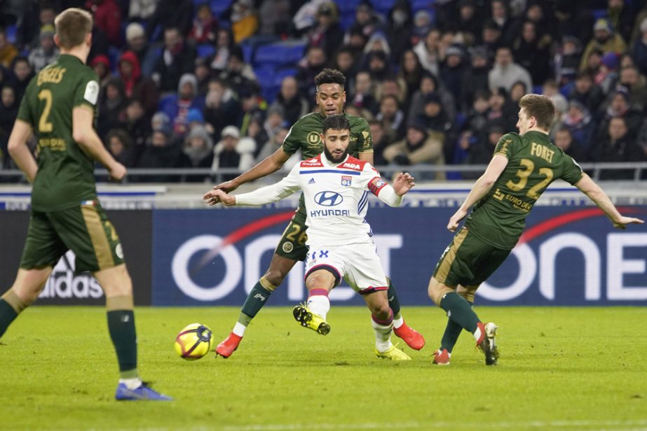 Lyon's Nabil Fekir (front center) challenges for the ball with Reims' players during their French League One soccer match in Decines, near Lyon, central France on Friday.