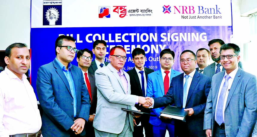 A.K.M. Kamal Uddin, Head of Corporate Banking of NRB Bank Limited and Md. Hossain Patwary, Director (Finance) of Bangladesh Rural Electrification Board, exchanging documents after signing an agreement at the Electrification Board on Sunday. From now NRB B