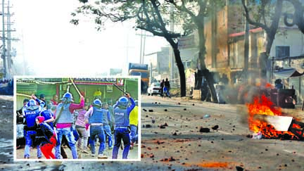 20 RMG workers injured in clash with police in Narsinghapur area of Ashulia during demo for 7th consecutive day as police charge batons on them to disperse the protesters (inset) on Sunday.