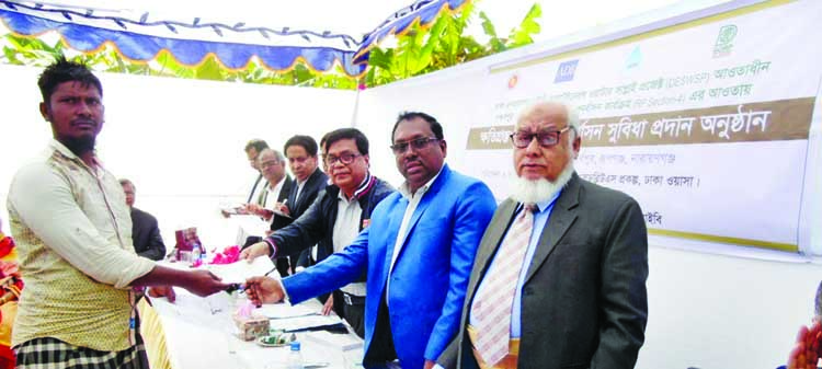 Chief Executive of Development Organisation for Rural Poor (DORP) AHM Noman, among others, at the cheque distribution among the affected people for rehabilitation organised recently by Dhaka WASA and DORP at Gandharbapur in Rupganj under Narayanganj distr