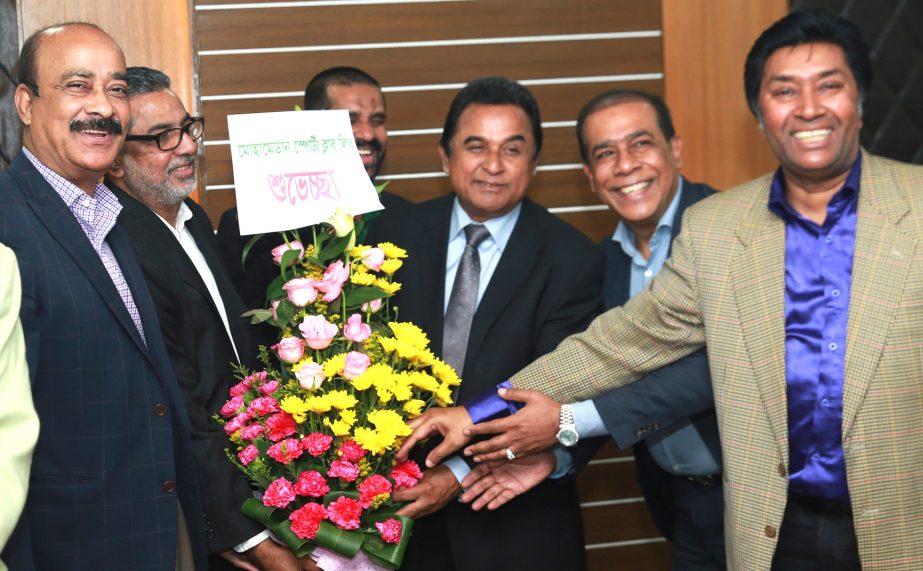 Representatives of Dhaka Mohammedan Sporting Club Ltd welcomed the Finance Minister A H M Mustafa Kamal with flowers at his own office of Economic Relations Division at Sher-e-Banglanagar in the capital on Sunday. Director in-charge of the