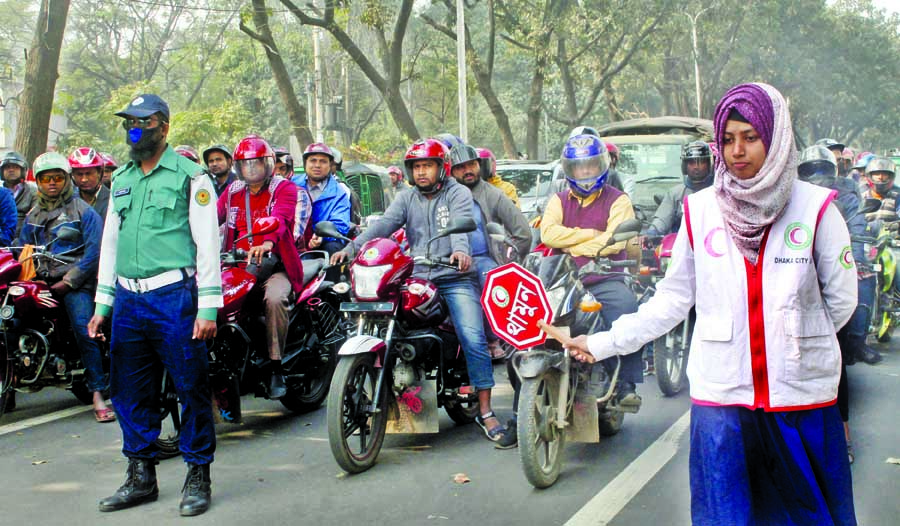 Scouts and Girls Guide members are working along with the Traffic Police personnel to maintain discipline on the roads and make cautions the pedestrians to avoid accidents. The photo was taken from Dainik Bangla crossing on Tuesday.