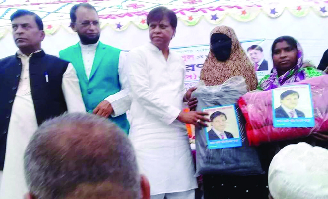 FENI: Kazi Shaheed Islam Papul, MP, distributing warm clothes among the poor people at Sonapur Union on Monday.