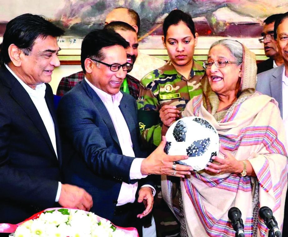 Awami League President and Prime Minister Sheikh Hasina receiving a football ( as a souvenir) from Senior Vice-President of Bangladesh Football Federation (BFF) Abdus Salam Murshedy, MP, when a delegation of BFF led by its President Kazi Md Salahuddin