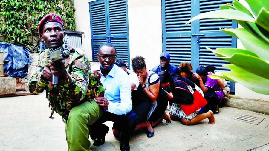 People are evacuated by a member of security forces. Intneret photo