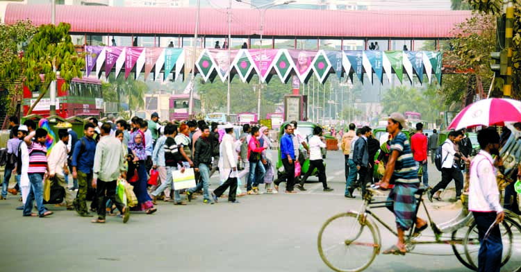 As traffic week continues for 3rd consecutive day on Thursday, a group of people passing the busy road defying traffic rules and ignoring nearby foot-over bridge in city's Shahbagh Intersection.
