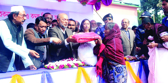 PANCHAGARH: State Minister for Disaster and Relied Dr Enamur Rahman MP distributing blankets and dry food among the poor people at Sakoa High School as Chief Guest on Wednesday.