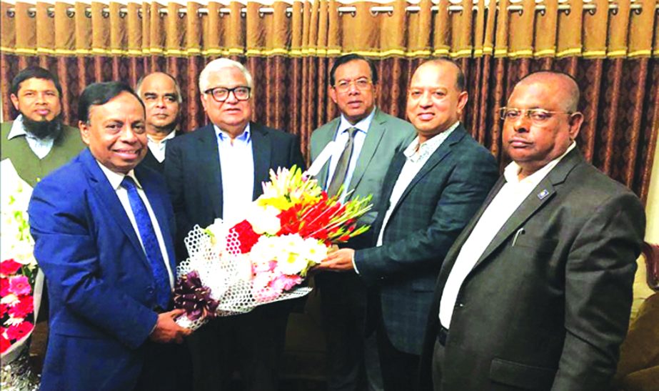A team led S M Amzad Hossain, Chairman of South Bangla Agriculture and Commerce (SBAC) Bank Limited, congratulating with bouquet to Dr. Mashiur Rahman on his reappointed as Economic Affair Adviser to Prime Minister on Wednesday evening at his residence. C