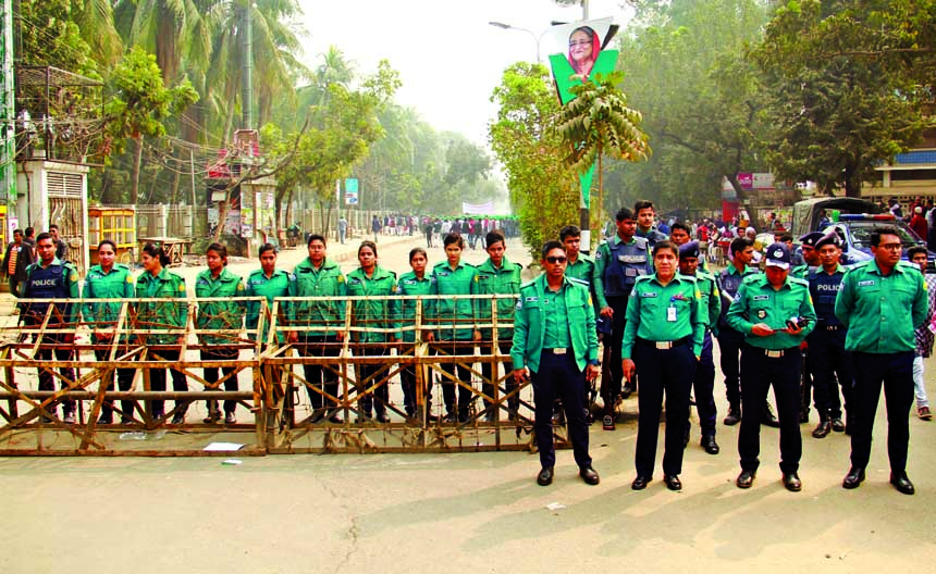 Law enforcers stand guard for security measures on the occasion of victory rally of Bangladesh Awami League in the city's Suhrawardy Udyan. The snap was taken from TSC area of Dhaka University on Saturday.