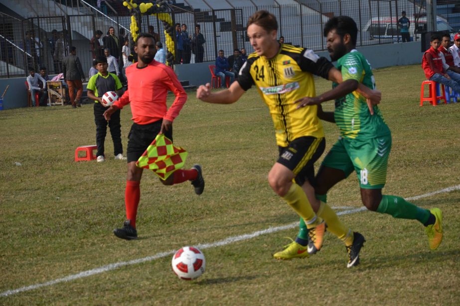An action from the football match of the Bangladesh Premier League between Saif Sporting Club and Rahmatganj MFS at Mymensingh Stadium on Saturday. Saif Sporting Club won the match 2-1.