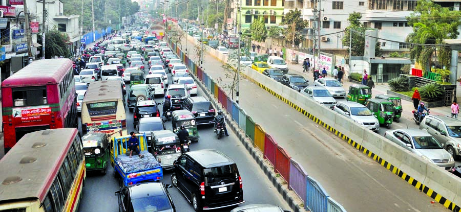 Hundreds of vehicles got stuck in a traffic gridlock on both sides of city street due to on going work of metro rail project. This photo was taken from Bangla Motor area on Sunday.