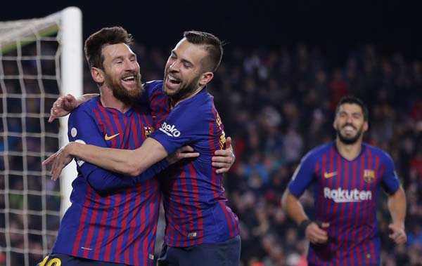 FC Barcelona's Lionel Messi (left) celebrates with his teammate Jordi Alba after scoring during the Spanish La Liga soccer match between FC Barcelona and Leganes at the Camp Nou stadium in Barcelona, Spain on Sunday.