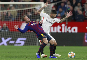 Sevilla's Banega (right) fight for the ball with FC Barcelona's Arthur Melo, during a Spanish Copa del Rey soccer match between Sevilla and FC Barcelona at the Ramon Sanche Pizjuan stadium in Seville, Spain on Wednesday.