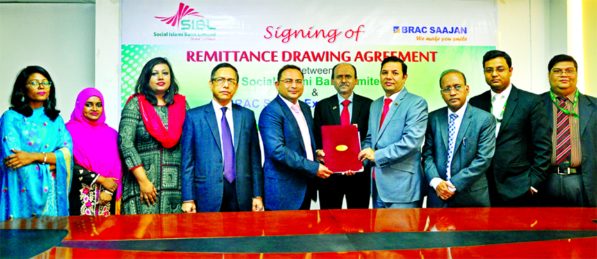 Md Akmal Hossain, Head of International Division of Social Islami Bank Limited (SIBL) and Abdus Salam, Managing Director of BRAC Saajan Exchange Limited, UK exchanging an agreement signing document for Inward Foreign Remittance drawing at the Bank's head