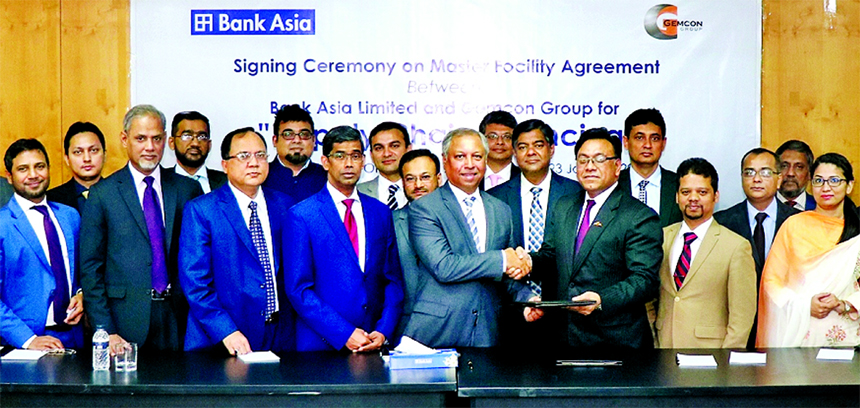 Shafiuzzaman, Head of Corporate & Large Loan of Bank Asia Limited and Captain (Retd) ZA Zakir, CFO of Gemcon Group, exchanging an agreement signing document on Master Facility for Supply Chain Financing at the Bank's corporate office in the city on Wedne