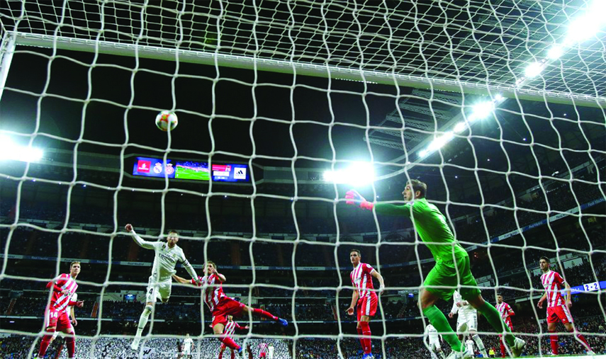 Real Madrid's Sergio Ramos heads for the ball to score during a Spanish Copa del Rey soccer match between Real Madrid and Girona in Madrid, Spain on Thursday.