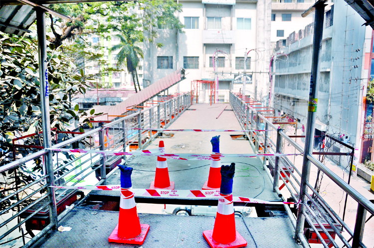 Authorities started to dismantle foot-over bridge in front of the Jatiya Press Club for construction work of Metro Rail Line on Friday.