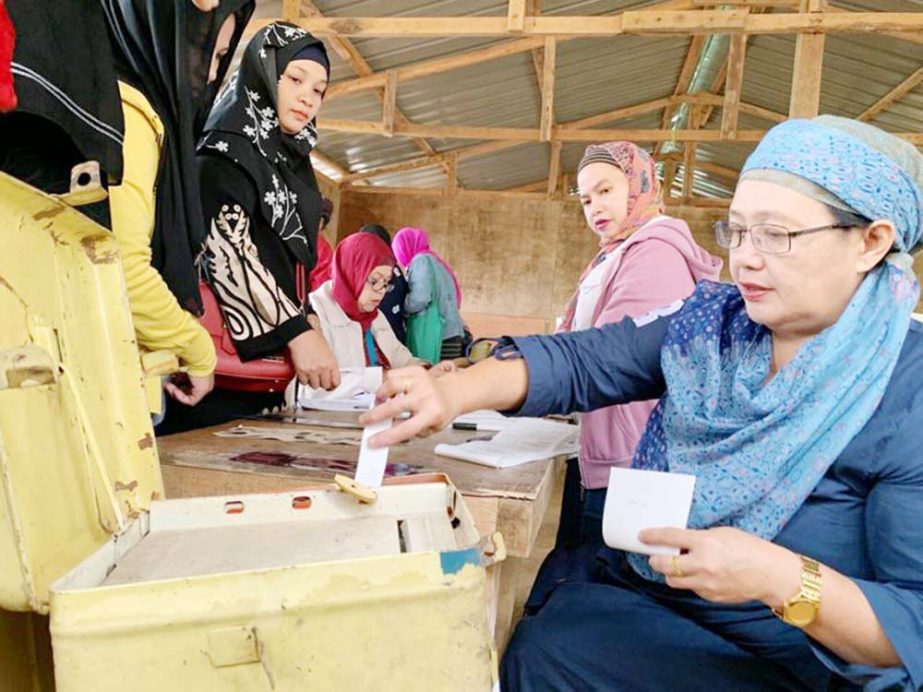 A woman casts her vote during the plebiscite on Bangsamoro Organic Law (BOL) at a voting precinct in Sultan Kudarat, Maguindanao province, Philippines.