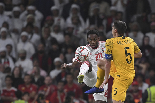 Australia's midfielder Mark Milligan (right) fights for the ball with United Arab Emirates' forward Said Rashid during the AFC Asian Cup quarterfinal soccer match between United Arab Emirates and Australia at Hazza Bin Zayed Stadium in Al Ain, United Ar