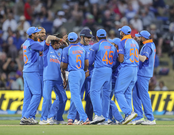 India congratulate MS Dhoni (center in helmet) after he stumped New Zealand's Ross Taylor during the second one day international between India and New Zealand at Blake Parkin Tauranga, New Zealand on Saturday.