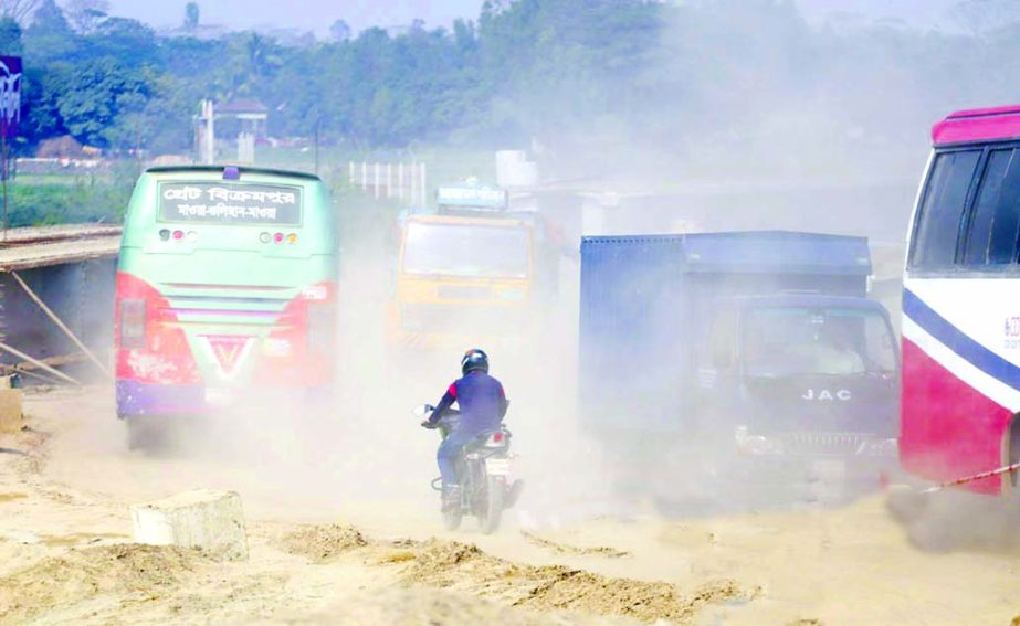 Rajendrapurâ€“Abdullahpur road is in deplorable situation as dusts deposited on its surface billowing in the air like storm, causing serious risk to commuters. This photo was taken on Saturday.