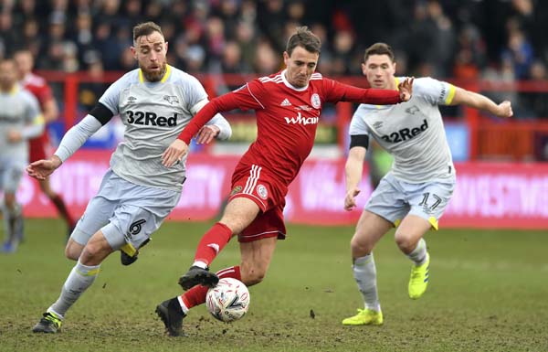 Accrington Stanley's Sean McConville (centre) battles against Derby County's Richard Keogh (left) and George Evans during their English FA Cup fourth round match at the Wham Stadium in Accrington, England on Saturday.