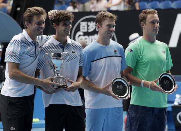 France's Nicolas Mahut (left) compatriot Pierre-Hugues Herbet pose with their trophy after defeating Finland's Henri Kontinen (right) and Australia's John Peers in the men's doubles final at the Australian Open tennis championships in Melbourne, Aust