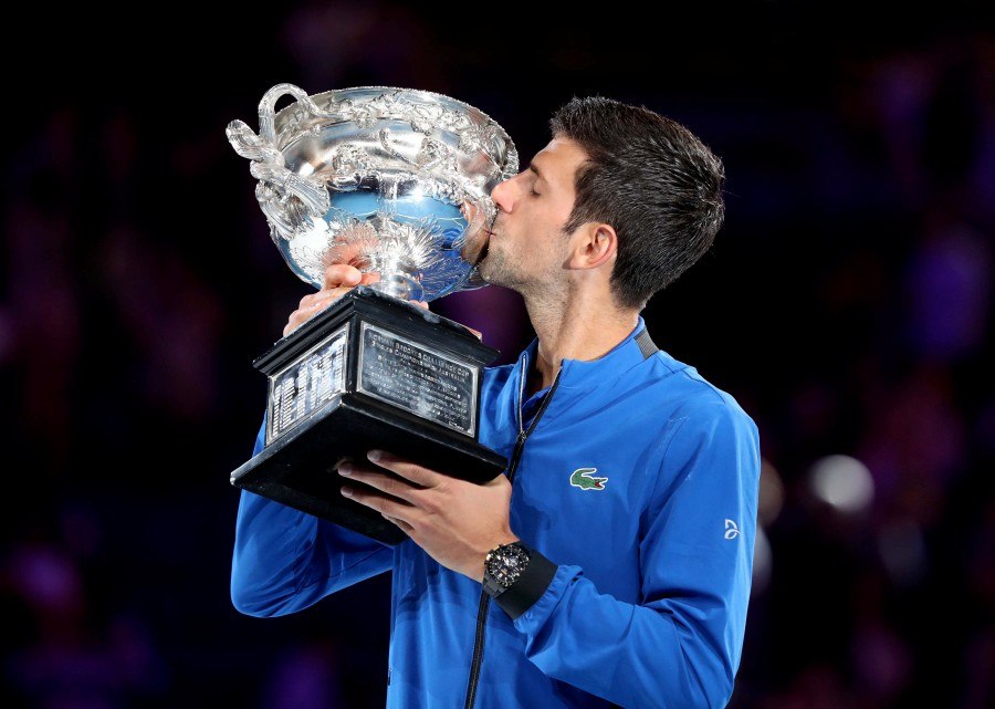 Serbia's Novak Djokovic kisses his trophy after winning the match against Spain's Rafael Nadal in the men's singles final on day 14 of the Australian Open tennis tournament in Melbourne on Sunday.