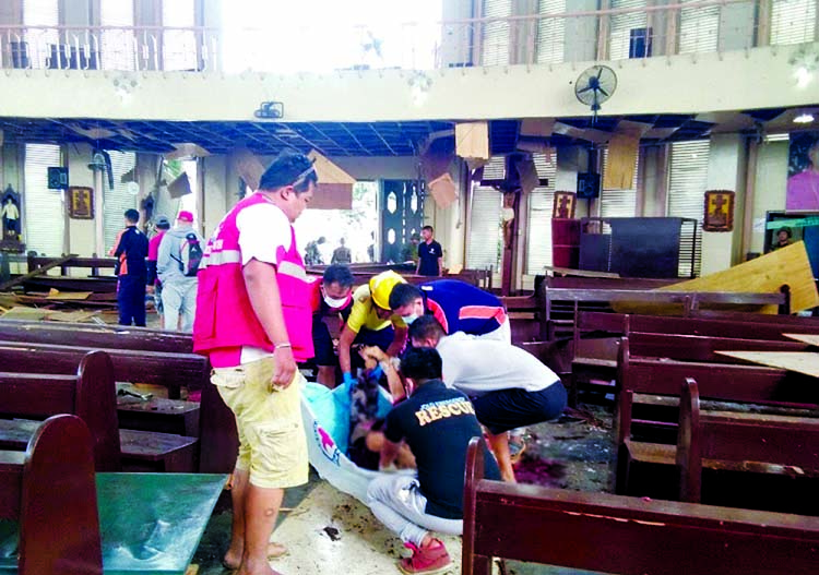 Members of the Philippines Red Cross attend to a casualty inside a church after a bombing attack in Jolo, Philippines on January 27, 2019 in this image obtained from social media. Internet photo